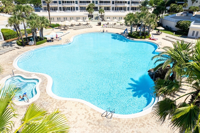 15400 Emerald Coast Pkwy Unit 301, Destin, FL 32541 - community pool featuring a patio area