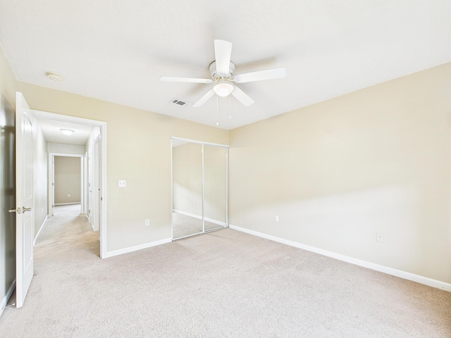 5261 Moore Loop, Crestview, FL 32536 - unfurnished bedroom featuring a closet, light colored carpet, and ceiling fan