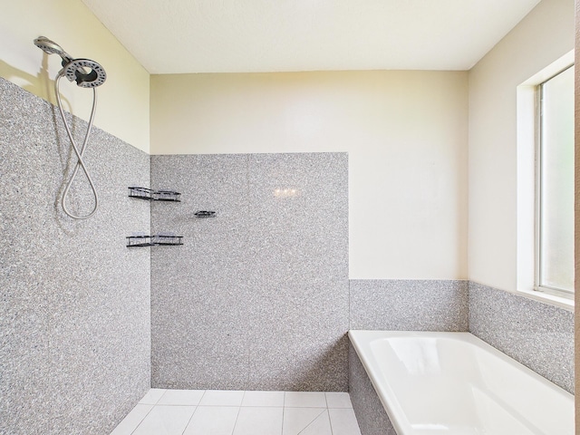 5261 Moore Loop, Crestview, FL 32536 - bathroom featuring a garden tub, tiled shower, and tile patterned flooring