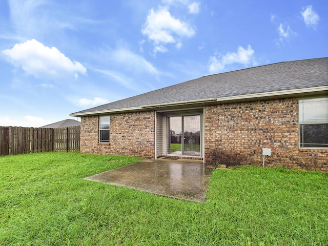 5261 Moore Loop, Crestview, FL 32536 - rear view of house with brick siding, roof with shingles, and a patio area