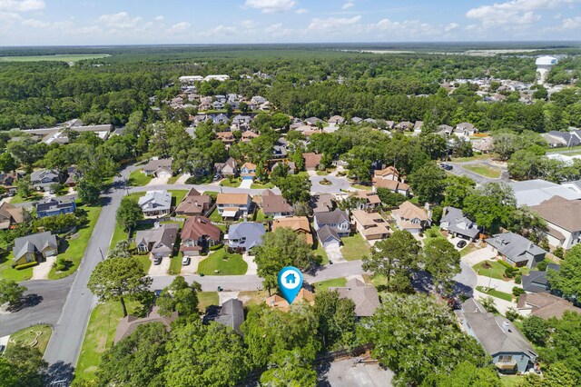 1405 Ariel Ln, Fort Walton Beach, FL 32547 - aerial overview of property's location featuring nearby suburban area and a heavily wooded area