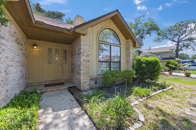 1405 Ariel Ln, Fort Walton Beach, FL 32547 - view of exterior entry featuring a chimney and brick siding