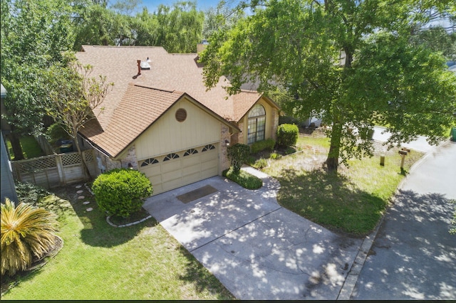 1405 Ariel Ln, Fort Walton Beach, FL 32547 - view of front of house featuring driveway, a shingled roof, a garage, and stone siding