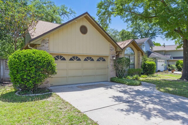 1405 Ariel Ln, Fort Walton Beach, FL 32547 - view of front of home with a garage, driveway, roof with shingles, and brick siding