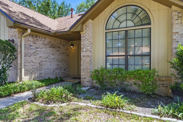 1405 Ariel Ln, Fort Walton Beach, FL 32547 - doorway to property featuring brick siding and a shingled roof