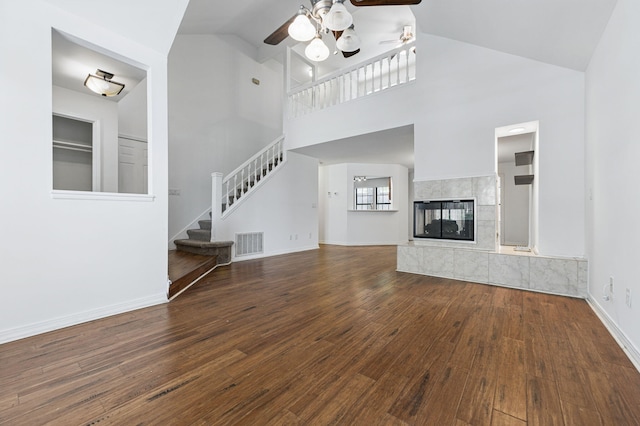 1405 Ariel Ln, Fort Walton Beach, FL 32547 - unfurnished living room with ceiling fan, wood finished floors, stairway, high vaulted ceiling, and baseboards