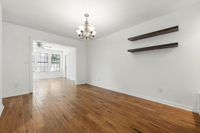 1405 Ariel Ln, Fort Walton Beach, FL 32547 - empty room with a chandelier, wood finished floors, a ceiling fan, and baseboards