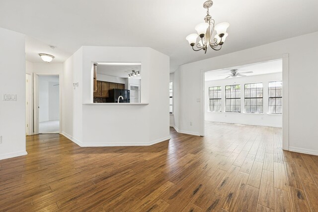 1405 Ariel Ln, Fort Walton Beach, FL 32547 - unfurnished living room featuring a chandelier, a ceiling fan, dark wood-type flooring, and baseboards