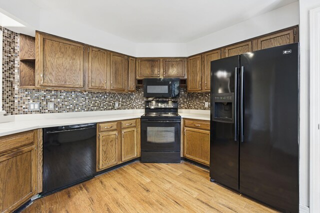 1405 Ariel Ln, Fort Walton Beach, FL 32547 - kitchen with black appliances, light countertops, and light wood-type flooring