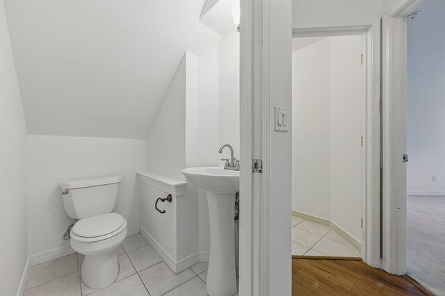 1405 Ariel Ln, Fort Walton Beach, FL 32547 - half bathroom with toilet, vaulted ceiling, and tile patterned floors