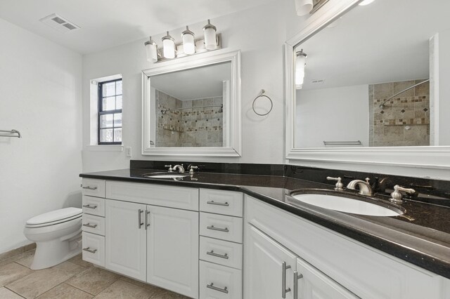 1405 Ariel Ln, Fort Walton Beach, FL 32547 - full bathroom with a tile shower, toilet, and double vanity