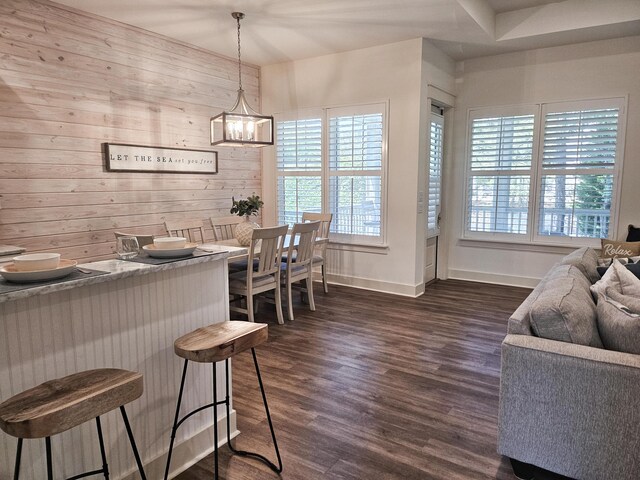 10 Gulfview Way, Santa Rosa Beach, FL 32459 - dining area featuring plenty of natural light, dark wood-style floors, a chandelier, baseboards, and wood walls