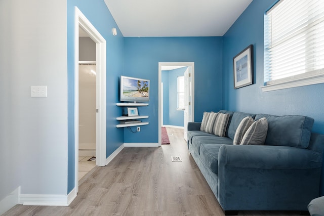 77 Mark St, Destin, FL 32541 - living area featuring plenty of natural light, wood finished floors, and baseboards