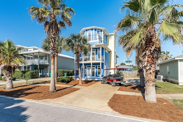 77 Mark St, Destin, FL 32541 - view of building exterior featuring central air condition unit, fence, and driveway