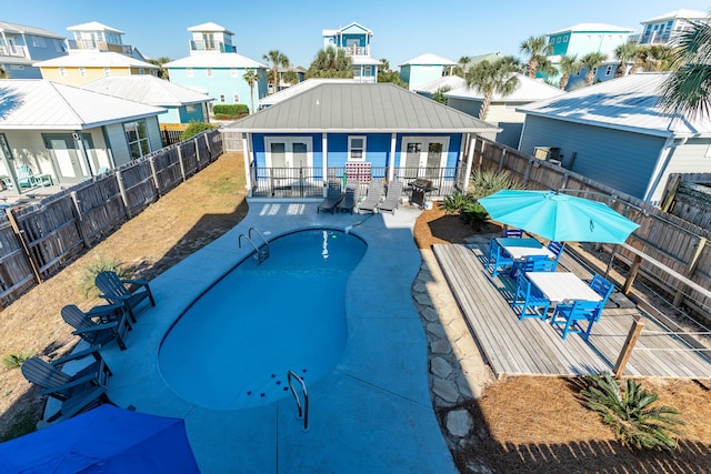 77 Mark St, Destin, FL 32541 - view of swimming pool featuring a fenced backyard, french doors, a residential view, and a patio