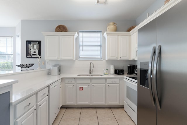 77 Mark St, Destin, FL 32541 - kitchen featuring white appliances, a sink, plenty of natural light, and light tile patterned floors