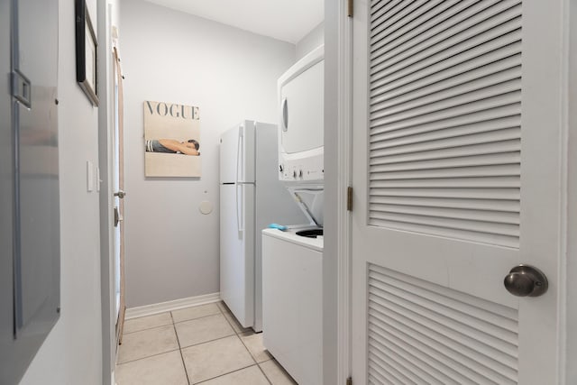 77 Mark St, Destin, FL 32541 - clothes washing area with stacked washer / drying machine, light tile patterned floors, and baseboards