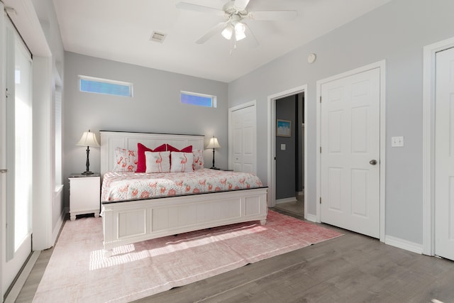 77 Mark St, Destin, FL 32541 - bedroom with light wood-type flooring, baseboards, and a ceiling fan