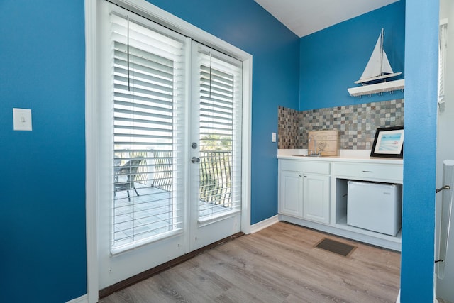 77 Mark St, Destin, FL 32541 - doorway featuring light wood-type flooring and baseboards