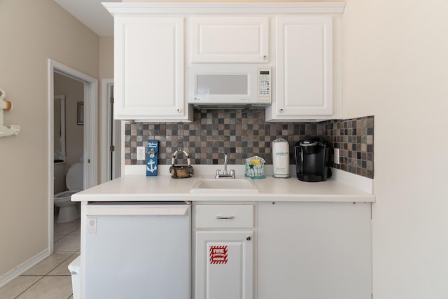 77 Mark St, Destin, FL 32541 - kitchen with white appliances, a sink, light tile patterned flooring, and decorative backsplash
