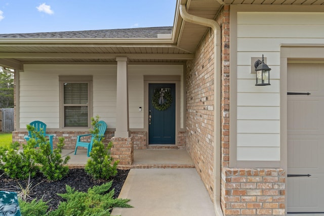 5414 Harmony Ln, Gulf Breeze, FL 32563 - entrance to property featuring covered porch, brick siding, and a shingled roof