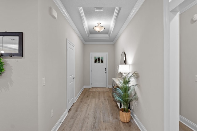 5414 Harmony Ln, Gulf Breeze, FL 32563 - entryway featuring light wood-style flooring, crown molding, baseboards, and a tray ceiling