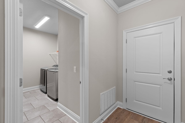 5414 Harmony Ln, Gulf Breeze, FL 32563 - clothes washing area featuring ornamental molding, washer and dryer, and baseboards