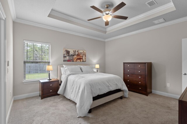 5414 Harmony Ln, Gulf Breeze, FL 32563 - bedroom featuring a tray ceiling, crown molding, light carpet, and baseboards