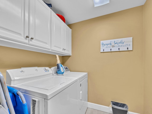 14825 Front Beach Rd Unit 1904, Panama City Beach, FL 32413 - laundry room featuring washing machine and dryer, cabinet space, light tile patterned floors, and baseboards