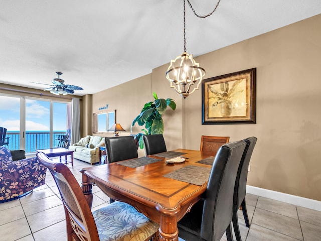 14825 Front Beach Rd Unit 1904, Panama City Beach, FL 32413 - dining area featuring a chandelier, light tile patterned flooring, a ceiling fan, and baseboards