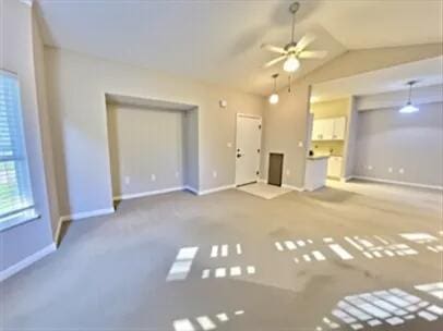 1501 N Partin Dr Unit 216, Niceville, FL 32578 - unfurnished living room featuring baseboards, ceiling fan, lofted ceiling, and carpet