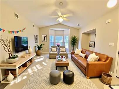 1501 N Partin Dr Unit 216, Niceville, FL 32578 - living room with a ceiling fan, lofted ceiling, and baseboards