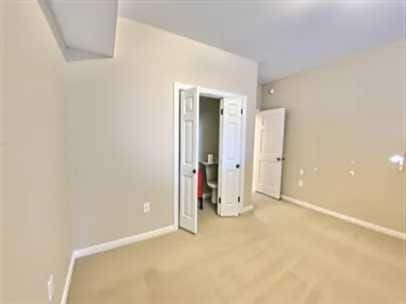 1501 N Partin Dr Unit 216, Niceville, FL 32578 - unfurnished bedroom featuring light colored carpet and baseboards