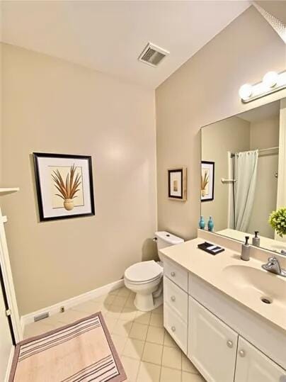 1501 N Partin Dr Unit 216, Niceville, FL 32578 - full bath with toilet, vanity, tile patterned floors, baseboards, and a shower with shower curtain