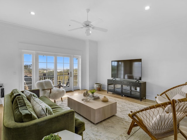 living area with light wood-style floors, recessed lighting, a ceiling fan, and baseboards