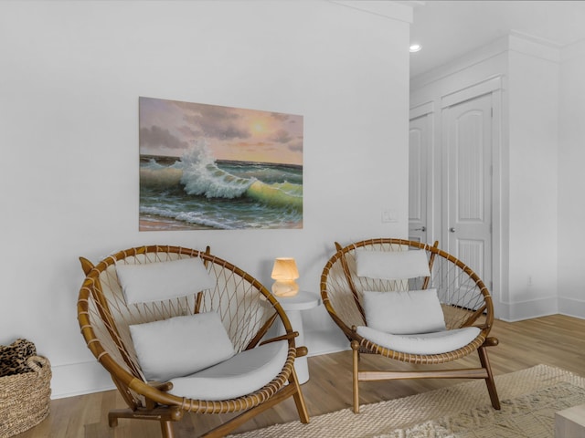 sitting room with recessed lighting, baseboards, and wood finished floors