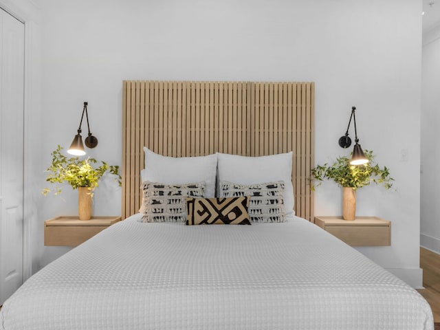 bedroom featuring wood finished floors and baseboards
