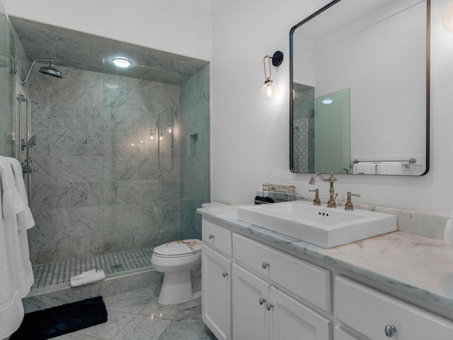 bathroom featuring tiled shower, toilet, vanity, and marble finish flooring