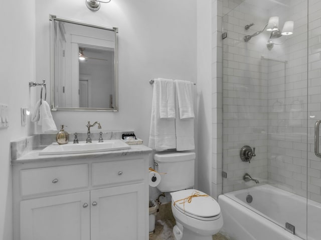 full bathroom featuring toilet, combined bath / shower with glass door, and vanity