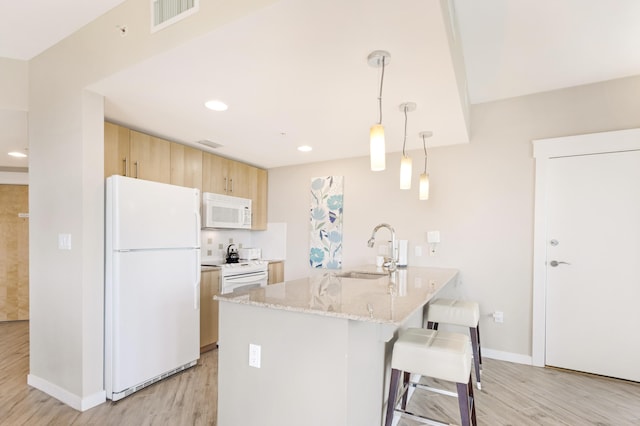 9800 Grand Sandestin Blvd Unit 5410/5412, Miramar Beach, FL 32550 - kitchen featuring white appliances, a sink, light wood finished floors, a peninsula, and recessed lighting