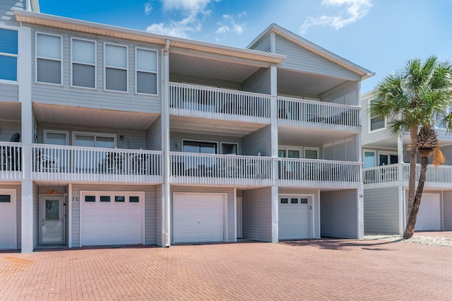 view of property featuring a garage and driveway