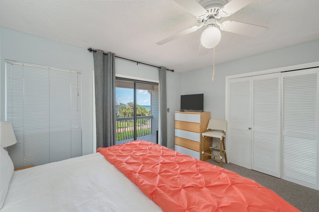 carpeted bedroom featuring access to exterior, a ceiling fan, a closet, and a textured ceiling