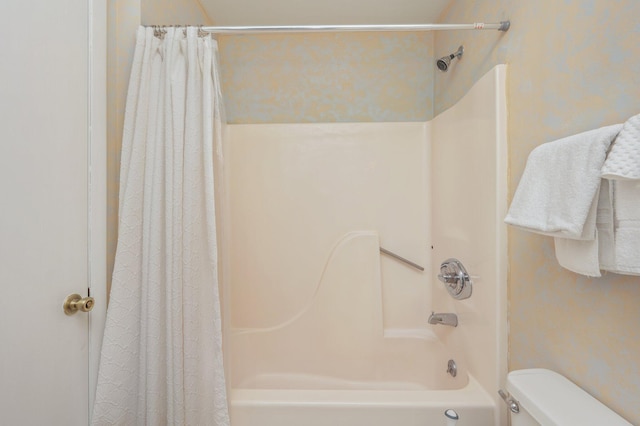 full bath with shower / bath combo with shower curtain and toilet