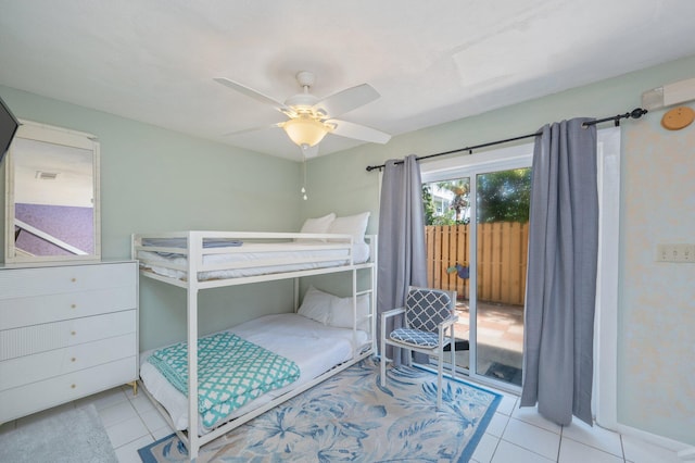tiled bedroom featuring access to outside, a ceiling fan, and baseboards