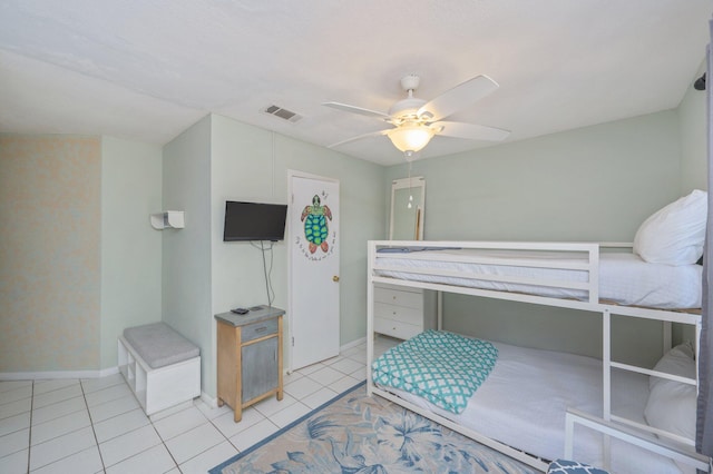 bedroom featuring light tile patterned floors, baseboards, and a ceiling fan