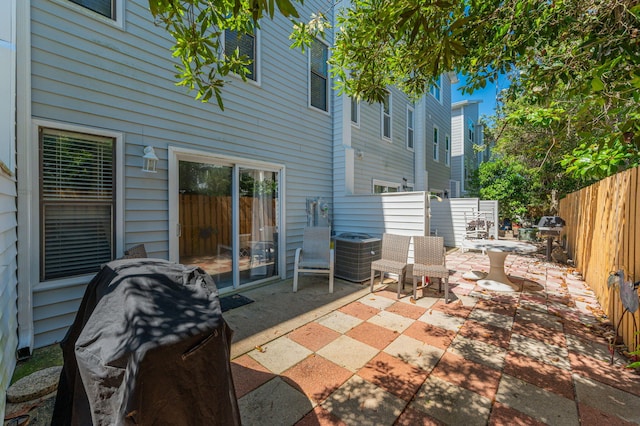 view of patio / terrace with central AC unit, fence, and area for grilling