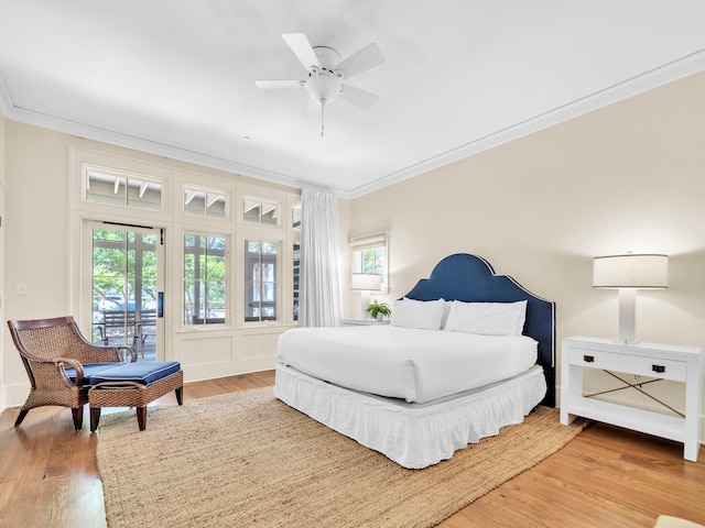 bedroom with ornamental molding, wood finished floors, and ceiling fan