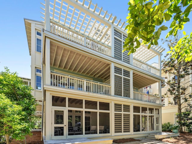 rear view of property with a balcony
