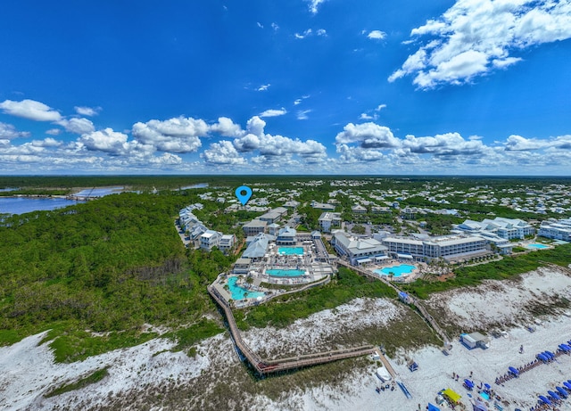 bird's eye view of a pool area and a large body of water