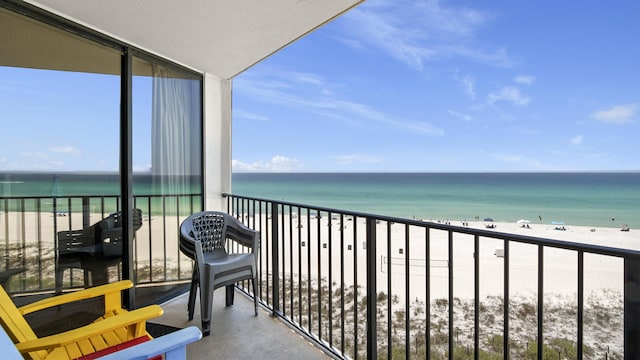 balcony with view of water and beach